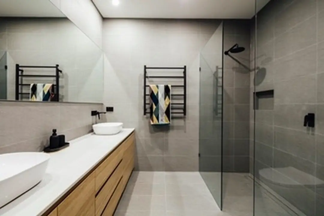 Bathroom with double vanity, walk-in shower and black tapware