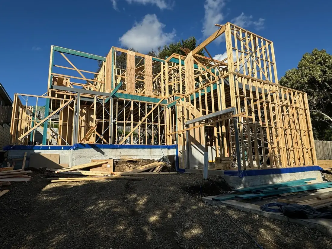 Double-storey timber frame going up on a sloping block