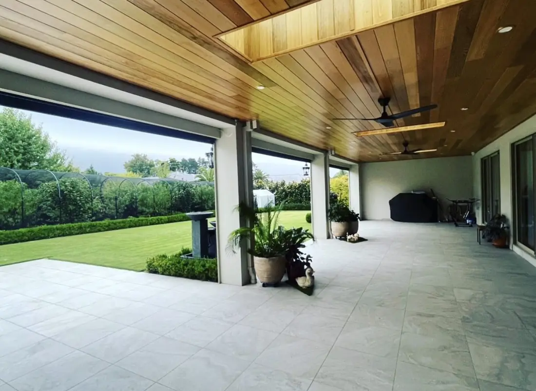 Covered alfresco with timber-lined ceiling, ceiling fans and garden views