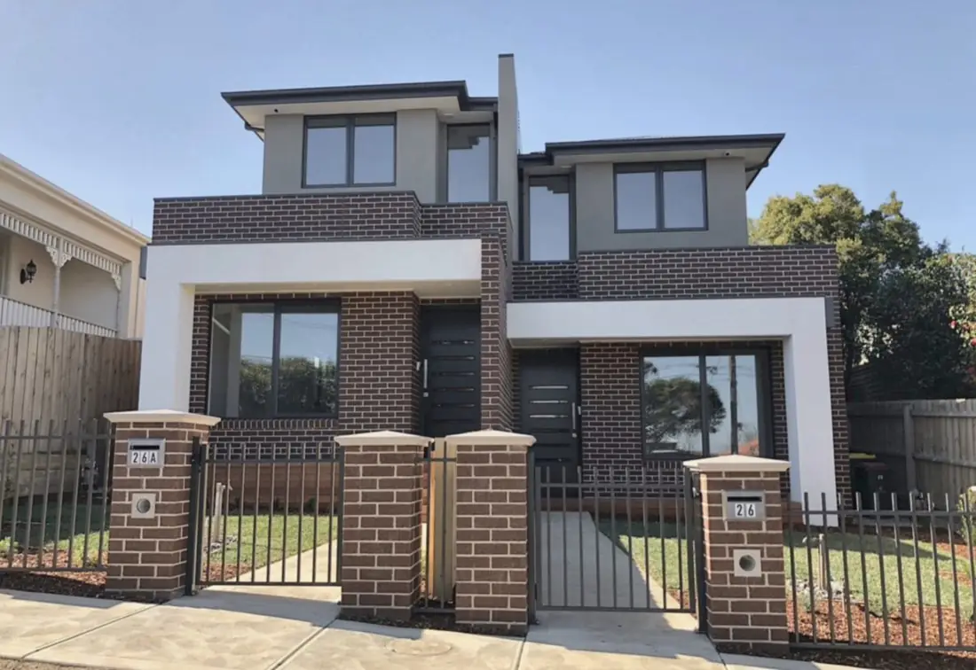 Brick and render double-storey duplex with matching front fence