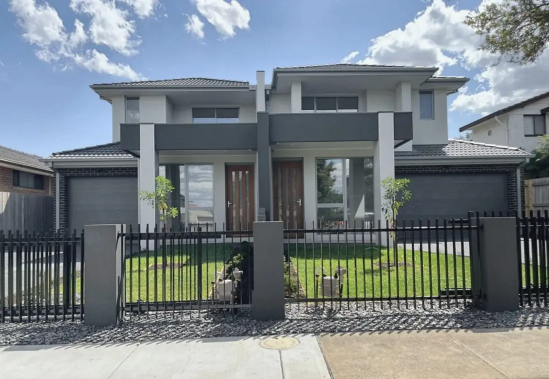 Double-storey side-by-side duplex with timber entry doors